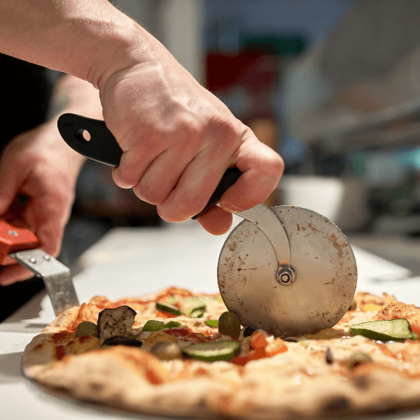 Chef cutting pizza